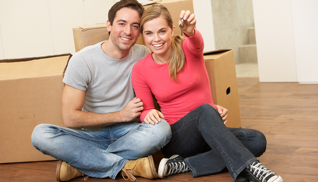 Young couple holding a key.